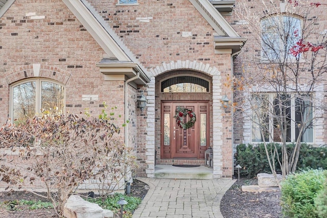 entrance to property featuring brick siding