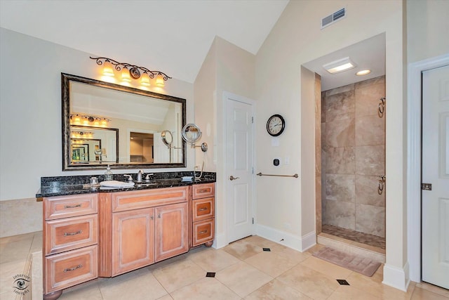 full bath with lofted ceiling, visible vents, a tile shower, and vanity