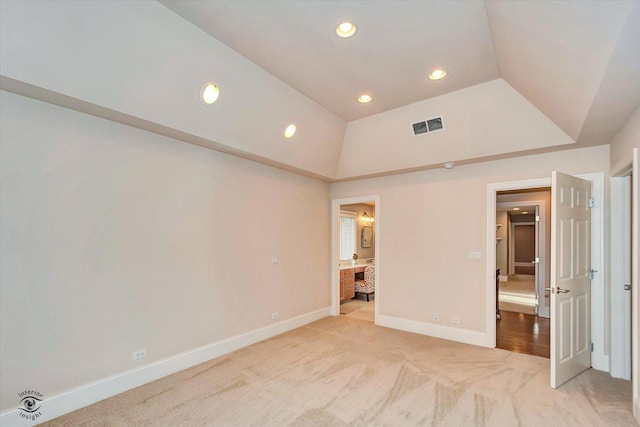 unfurnished bedroom featuring recessed lighting, light colored carpet, visible vents, vaulted ceiling, and baseboards