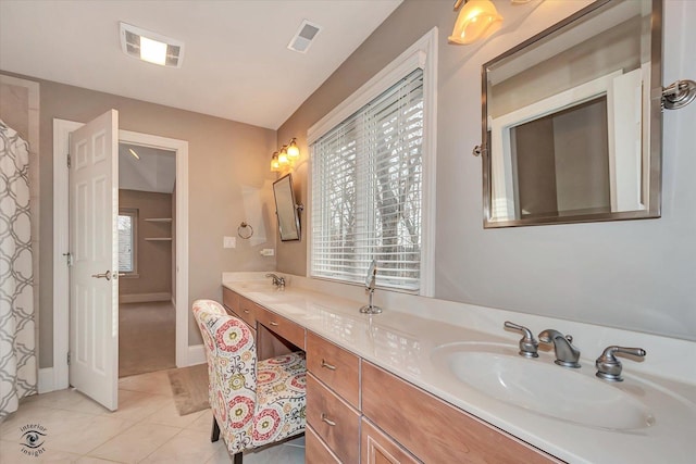 bathroom with tile patterned flooring, visible vents, and a sink