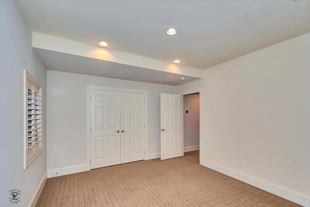 unfurnished bedroom with recessed lighting, light carpet, and baseboards