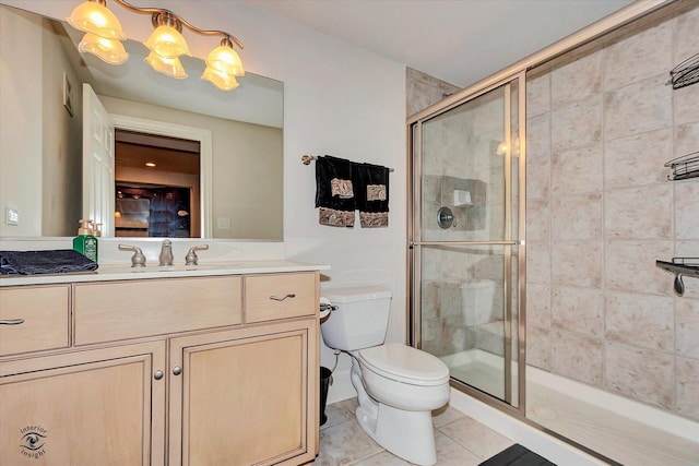 full bath with a stall shower, toilet, tile patterned floors, vanity, and a notable chandelier