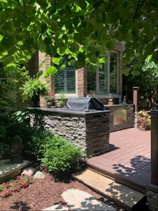 view of patio with a deck and an outdoor kitchen