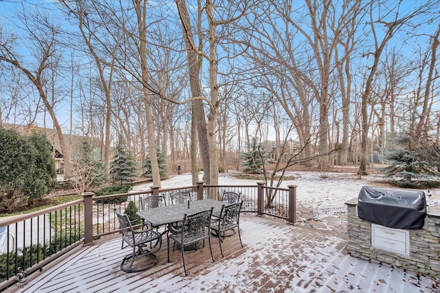 snow covered deck with a grill and outdoor dining area