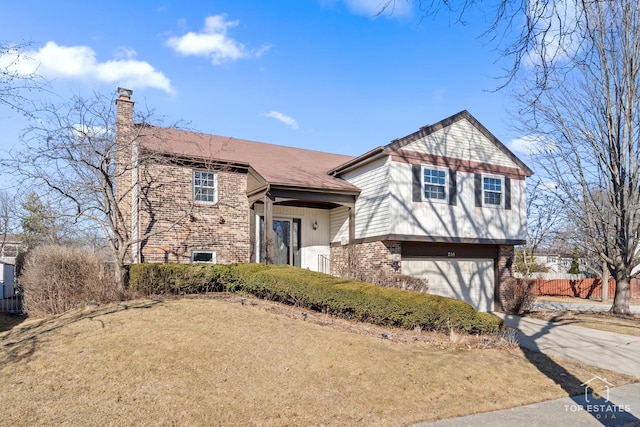 split level home with a chimney, fence, concrete driveway, and brick siding