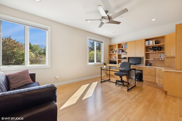 office space with ceiling fan and light hardwood / wood-style flooring