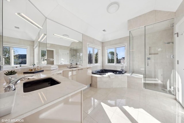 bathroom featuring separate shower and tub, vaulted ceiling, and plenty of natural light