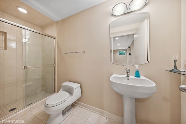 bathroom with an enclosed shower, tile patterned flooring, toilet, and sink