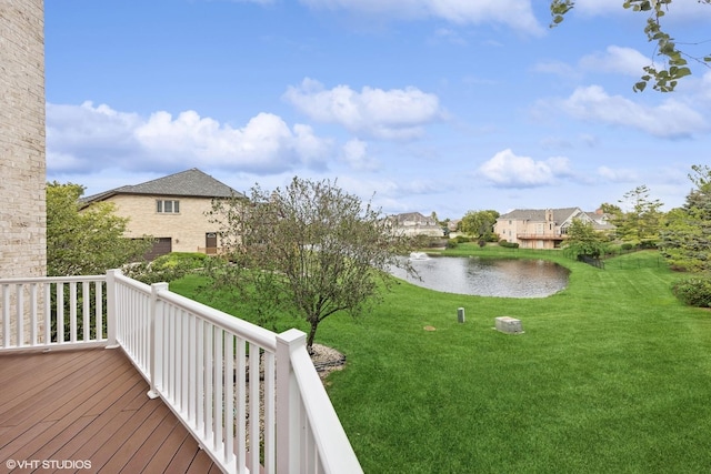 view of yard with a water view and a balcony