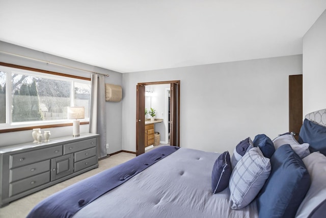 bedroom featuring light carpet and baseboards