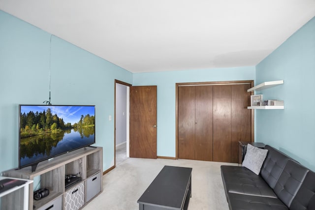 living area with baseboards and light colored carpet