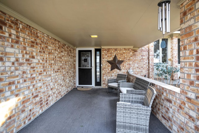 doorway to property featuring brick siding