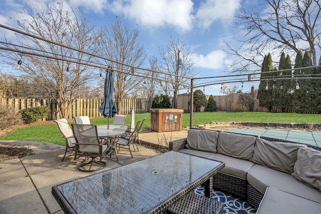 view of patio / terrace featuring outdoor dining area, a fenced backyard, a storage shed, an outdoor structure, and an outdoor living space