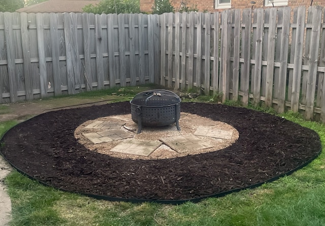 view of yard with a fire pit and a fenced backyard