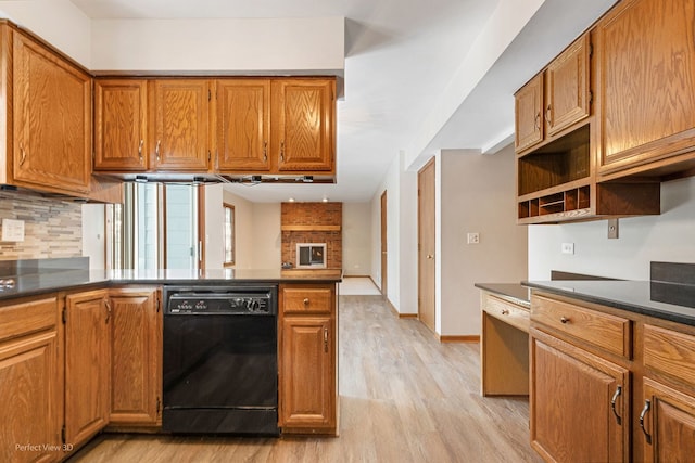 kitchen featuring tasteful backsplash, dishwasher, and light wood-type flooring