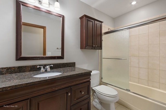 full bathroom featuring vanity, toilet, and combined bath / shower with glass door