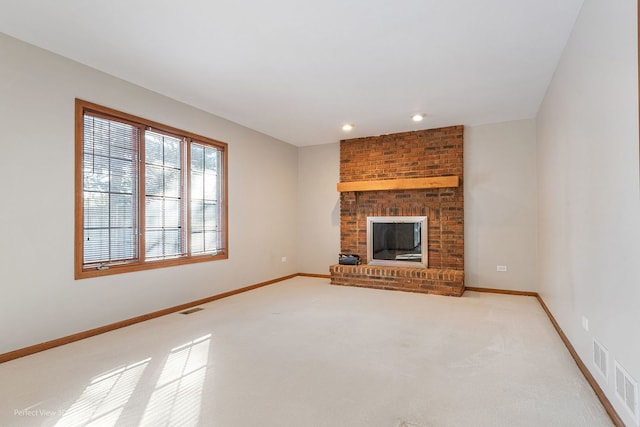 unfurnished living room featuring a fireplace and light colored carpet