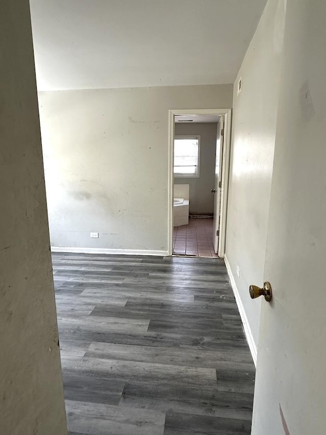 unfurnished room with dark hardwood / wood-style flooring