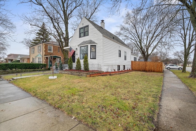 view of side of property with a lawn