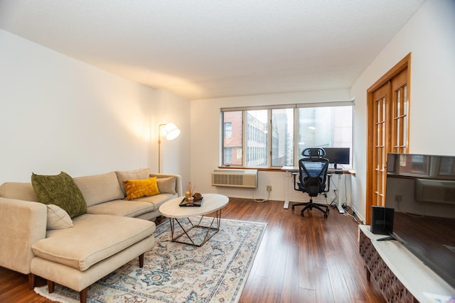 living room with dark hardwood / wood-style flooring and an AC wall unit