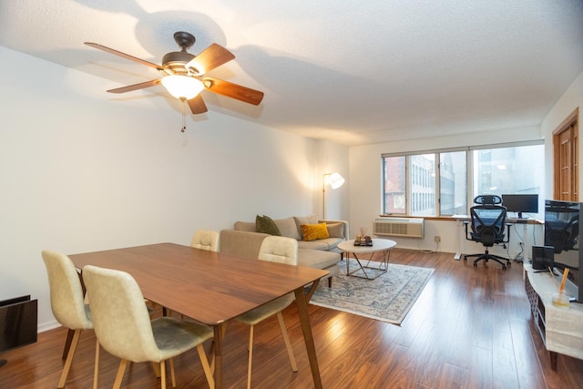 dining area featuring hardwood / wood-style flooring, ceiling fan, and a textured ceiling