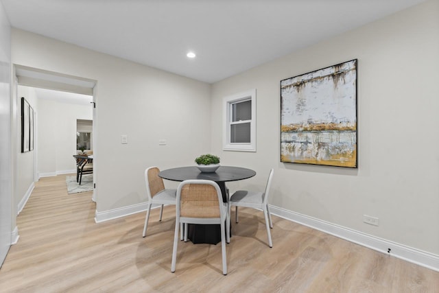 dining space featuring light wood-type flooring