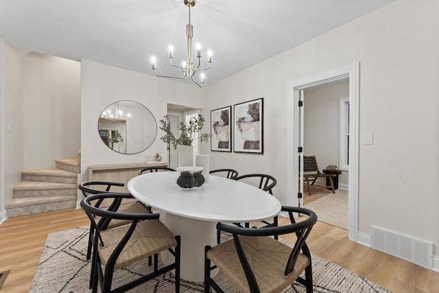 dining room featuring a chandelier and light wood-type flooring