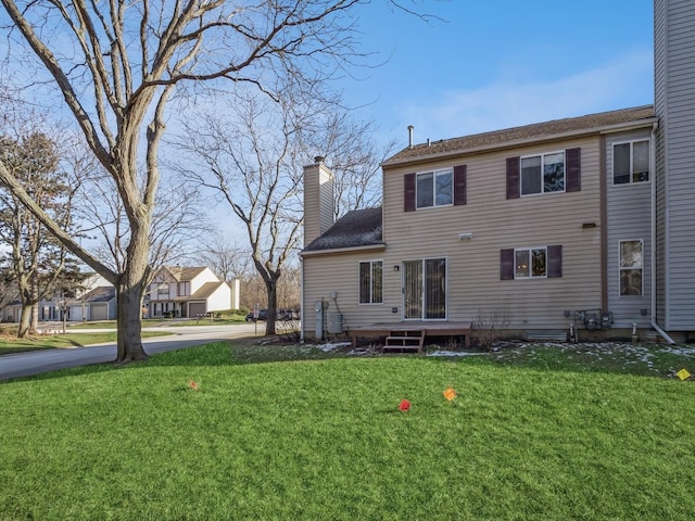 back of property featuring a yard