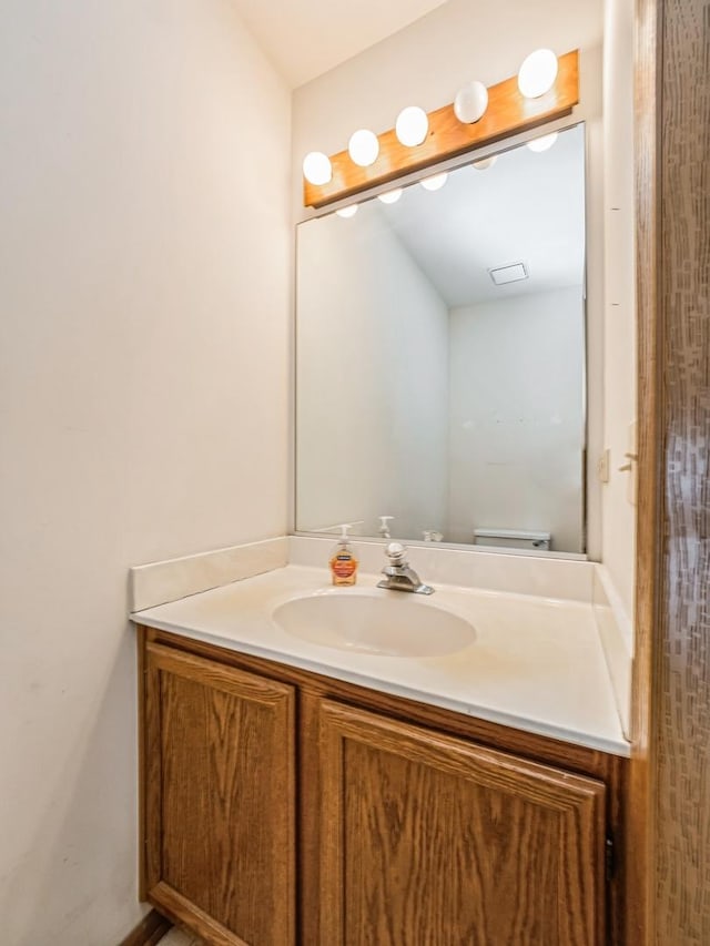 bathroom with toilet and vanity