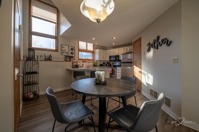 dining space with hardwood / wood-style flooring