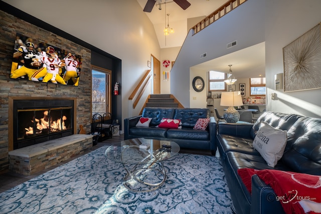 living room featuring ceiling fan, vaulted ceiling, and a fireplace