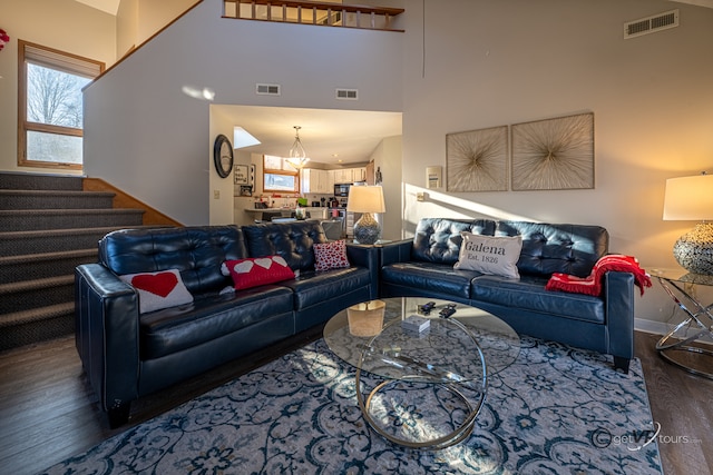 living room featuring dark hardwood / wood-style floors and a high ceiling