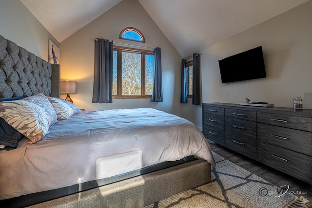 bedroom featuring vaulted ceiling and dark carpet