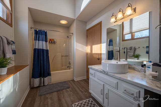 bathroom featuring wood-type flooring, vanity, and shower / bathtub combination with curtain