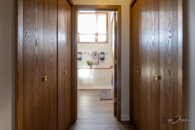 hallway with light hardwood / wood-style flooring