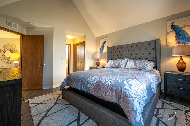 bedroom featuring lofted ceiling, a closet, and dark hardwood / wood-style floors