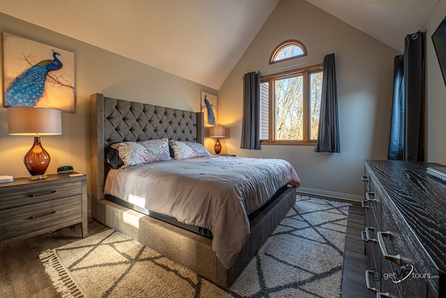 bedroom featuring hardwood / wood-style flooring and lofted ceiling