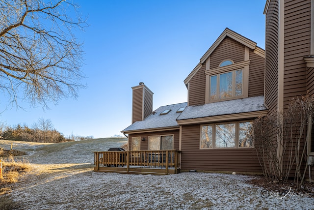 back of property with a wooden deck