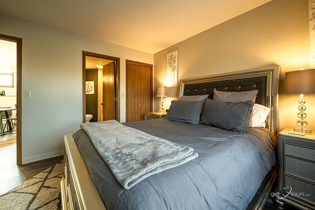 bedroom featuring hardwood / wood-style floors and ensuite bath