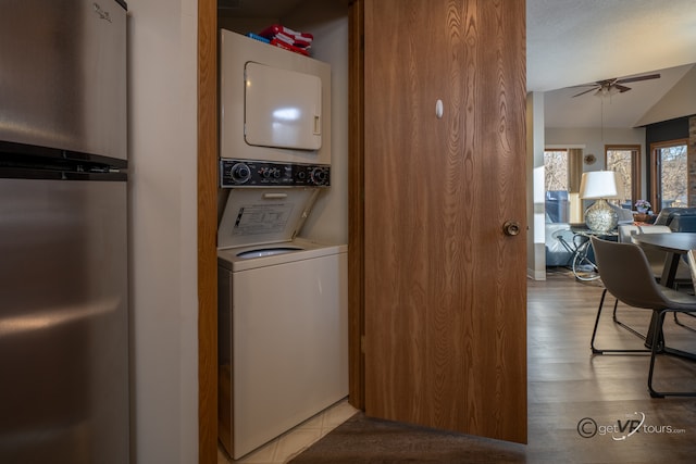 laundry area featuring light wood-type flooring, ceiling fan, and stacked washer / dryer