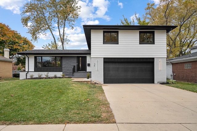 view of front of property with a garage and a front lawn