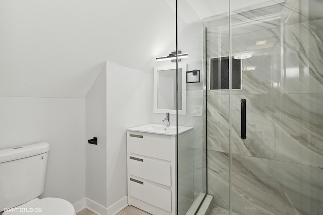 bathroom with lofted ceiling, vanity, an enclosed shower, and toilet