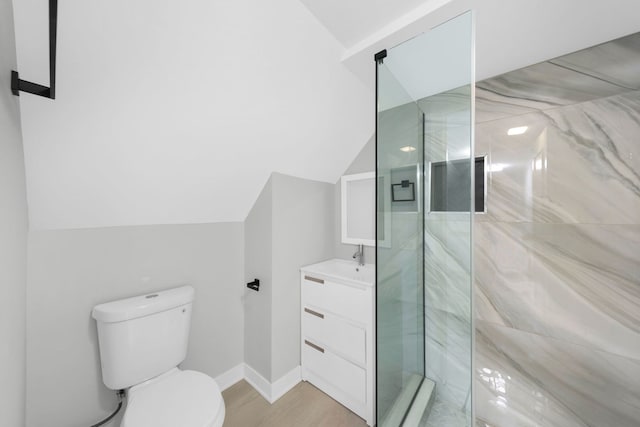 bathroom with walk in shower, wood-type flooring, lofted ceiling, toilet, and vanity