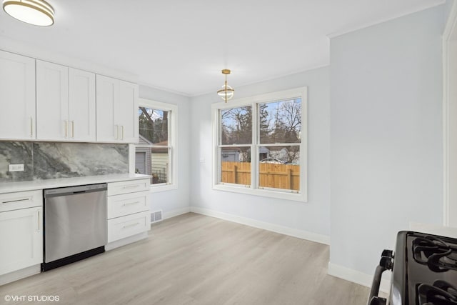 kitchen with gas stove, tasteful backsplash, stainless steel dishwasher, pendant lighting, and white cabinets