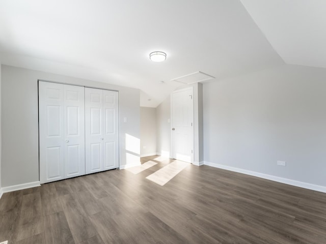 additional living space with dark hardwood / wood-style floors and vaulted ceiling