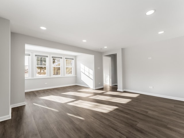 unfurnished living room with dark wood-type flooring