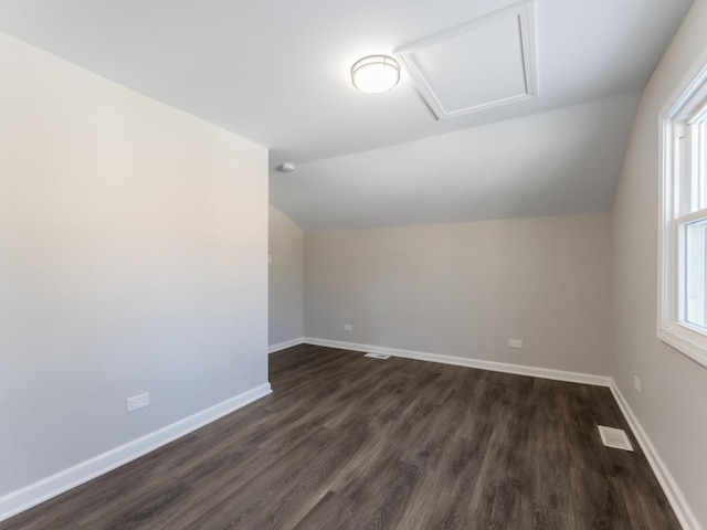 bonus room with dark hardwood / wood-style floors and lofted ceiling