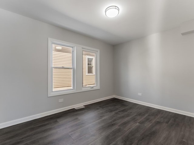 spare room with dark hardwood / wood-style flooring