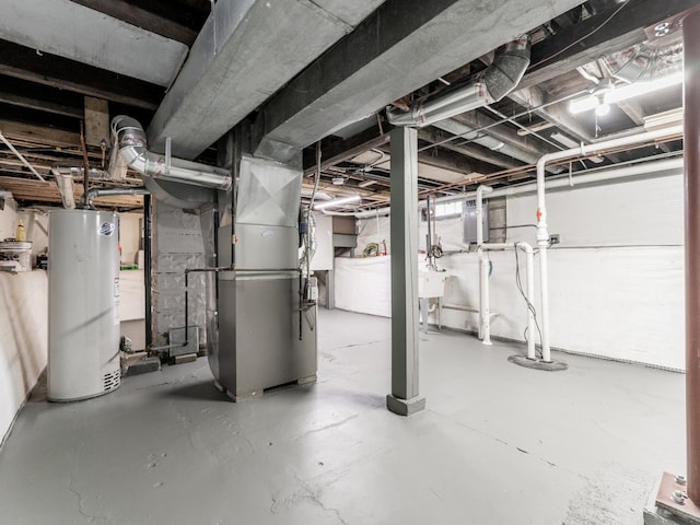 basement with gas water heater, heating unit, and sink