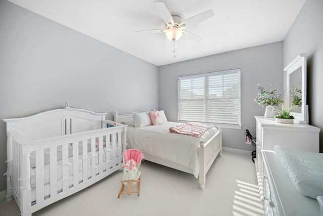 carpeted bedroom featuring ceiling fan